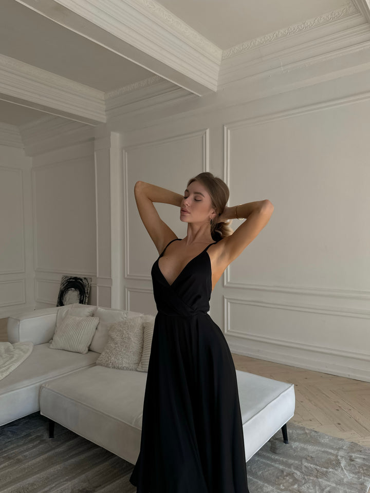 Woman wearing black silk slip midi dress for a formal evening event