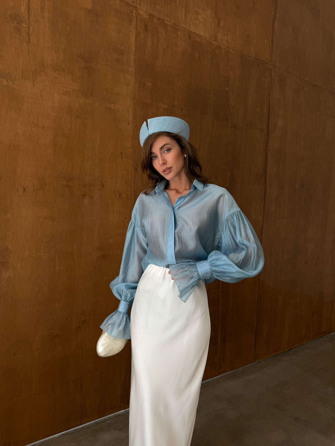 Full-length front view of the ice blue sheer lyocell blouse with tailored collar and long sleeves