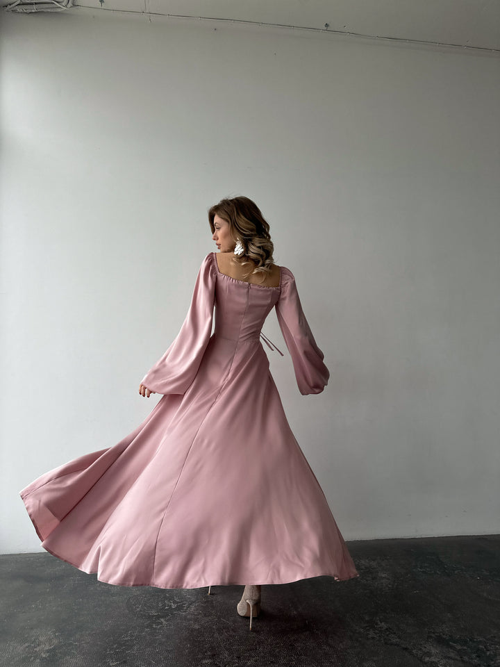 Flowing blush satin gown with a classic sweetheart neckline, bishop sleeves, and a floor-sweeping skirt. A gorgeous spring formal dress ensemble.
