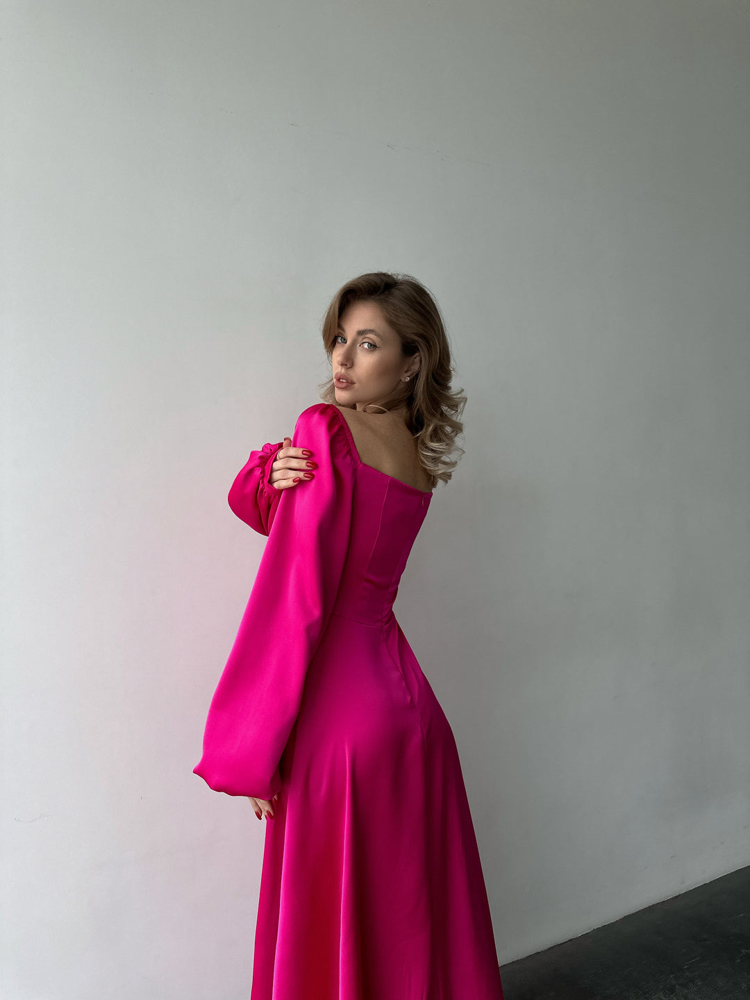 Flowing bright pink satin gown with a flattering sweetheart neckline, bishop sleeves, and a floor-sweeping skirt. A gorgeous formal event ensemble.