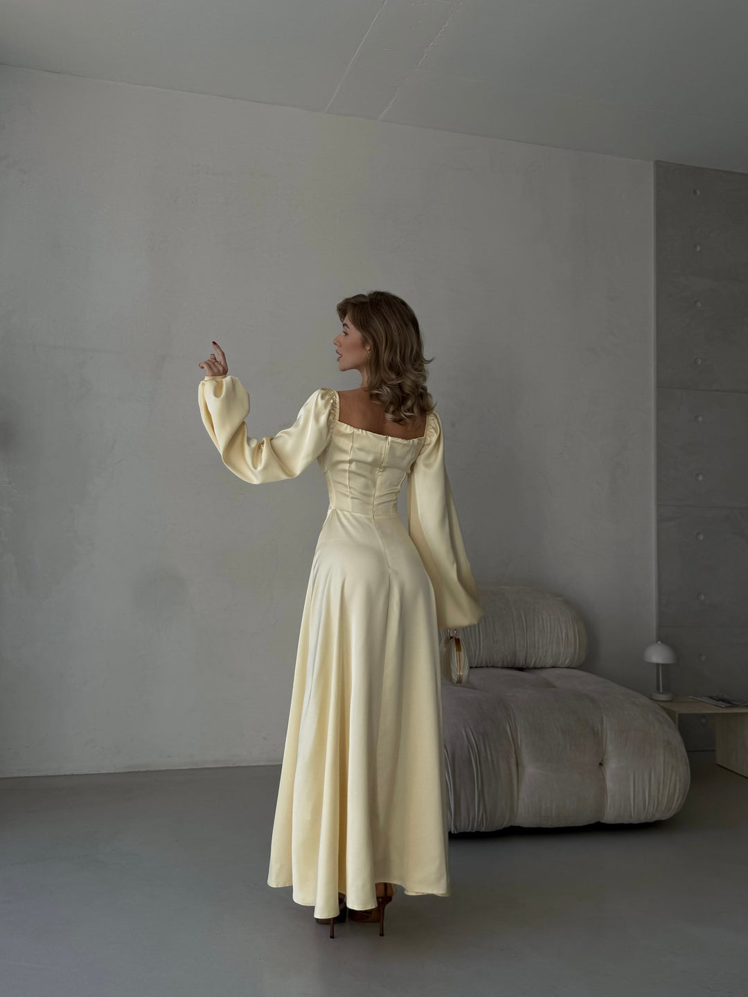 Chic pastel yellow silk maxi dress with on-or-off shoulder puff sleeves and a side slit. A modern feminine silhouette perfect for a chic NYC cocktail dress look.