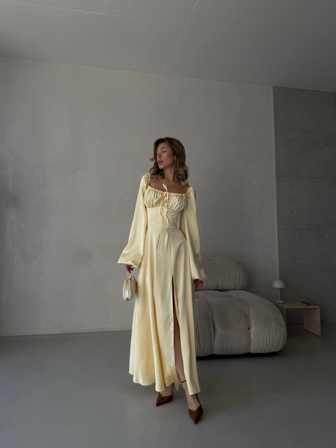 Premium butter yellow silk-like maxi gown featuring delicate draped sleeves, a sweetheart neckline, and a leg slit. An elegant outfit for a destination vacation.