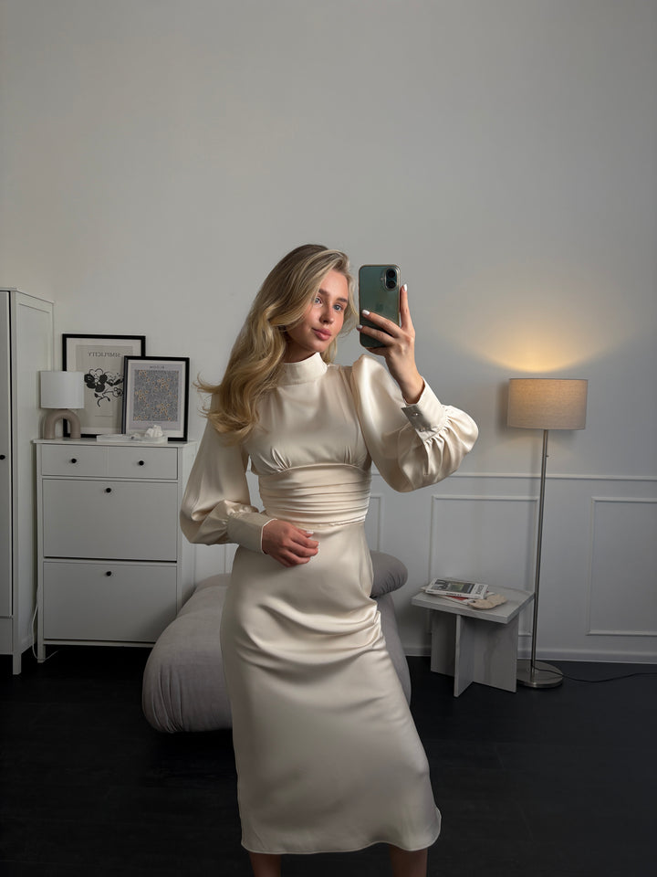 Ivory satin midi dress with long sleeves and bow tie neckline — full length view