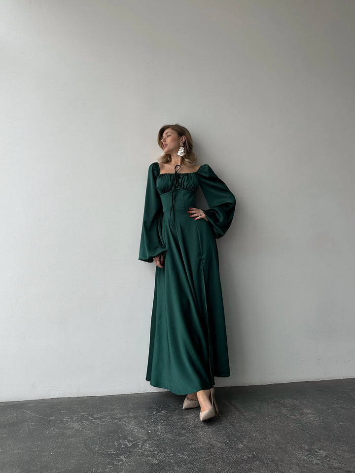 Flowing dark green satin gown with a classic sweetheart neckline, bishop sleeves, and a floor-sweeping skirt. A gorgeous formal event ensemble.