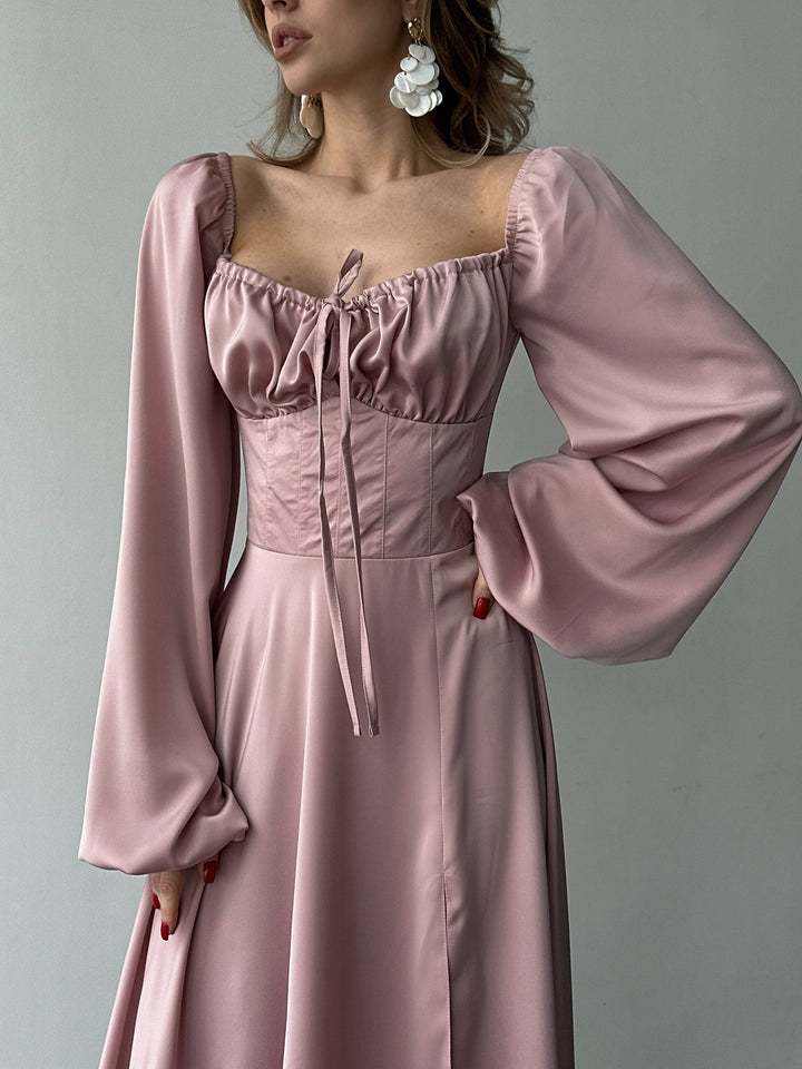 Flowing blush pink satin gown with off-the-shoulder balloon sleeves and a high slit. A modern feminine option for a chic Miami vacation dress.