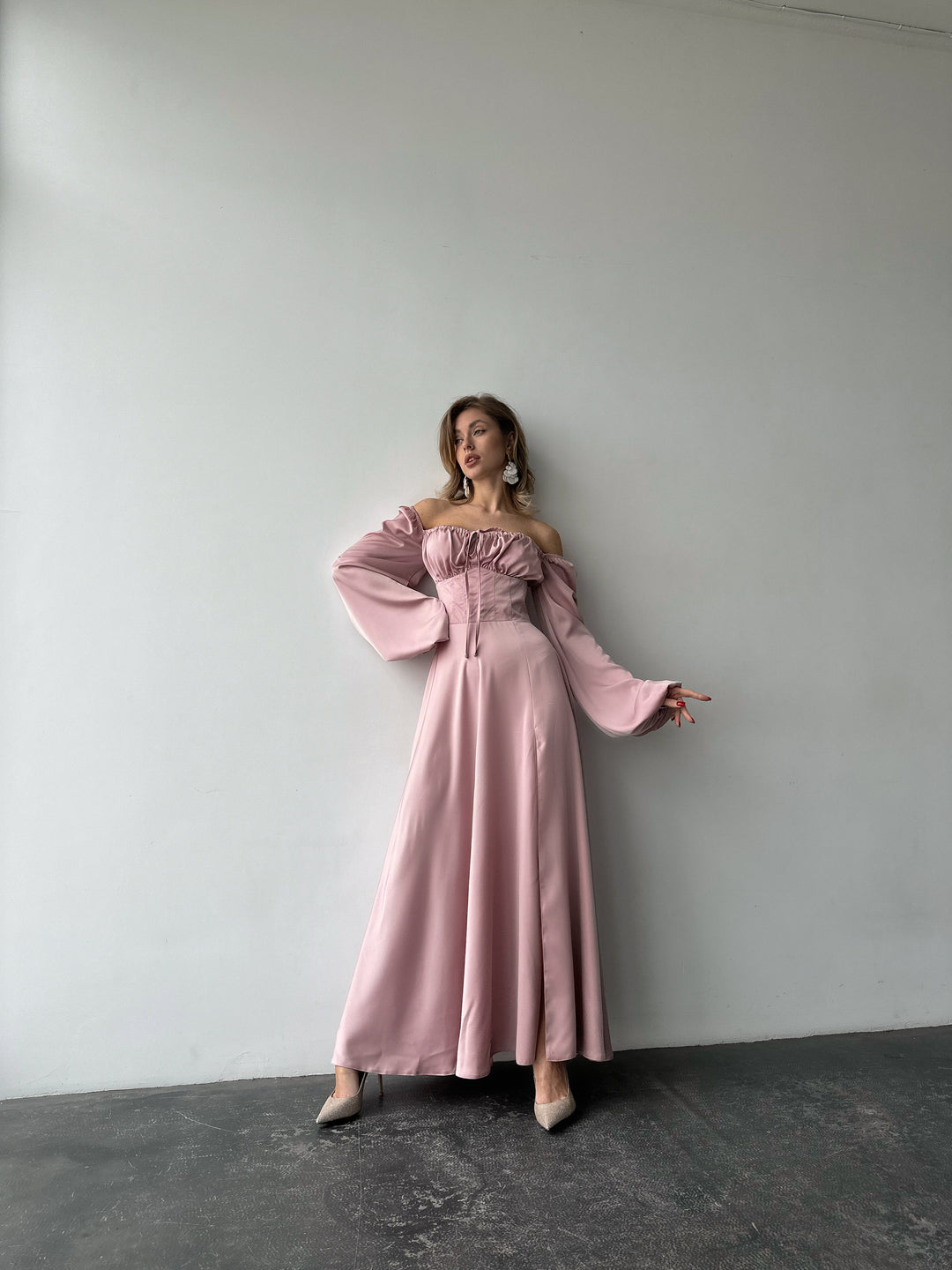 Long-sleeve light pink silk-blend formal dress highlighting a fitted bodice and sweeping maxi skirt. Ideal for an upscale bridesmaid dress look.