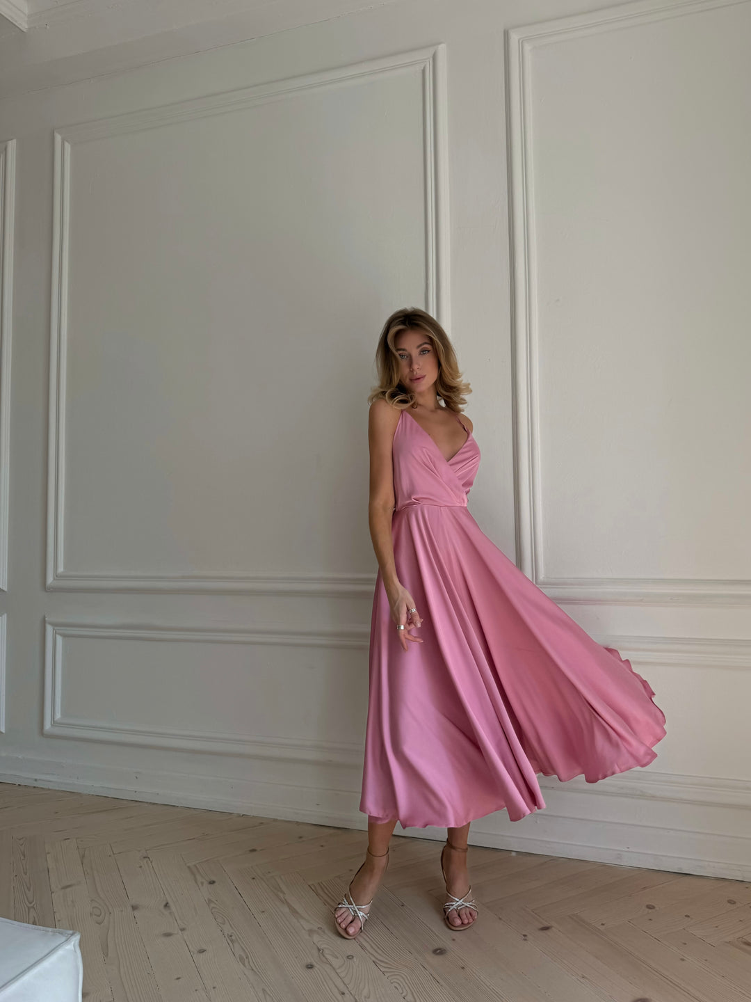 Back view of dusty pink silk midi dress with open back and bow tie closure