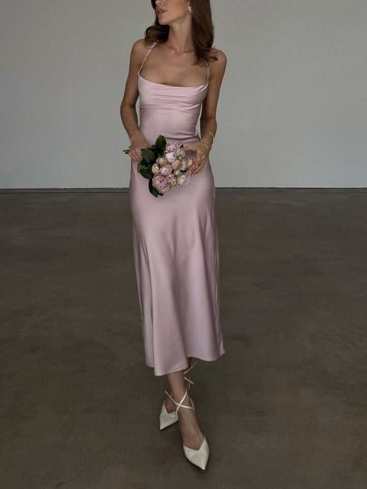 Dusty pink silk satin slip dress, cropped front view from neckline to shoes: draped cowl neck, fitted bias-cut bodice and midi skirt, ivory ankle-strap heels.