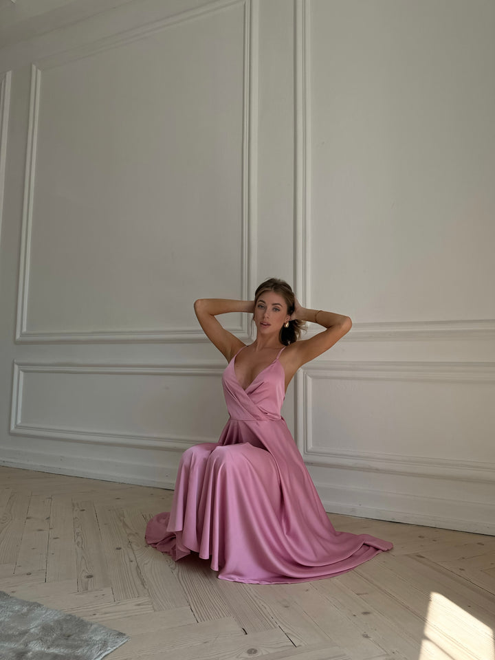 Dusty pink silk slip dress with elegant open bow back — styled look