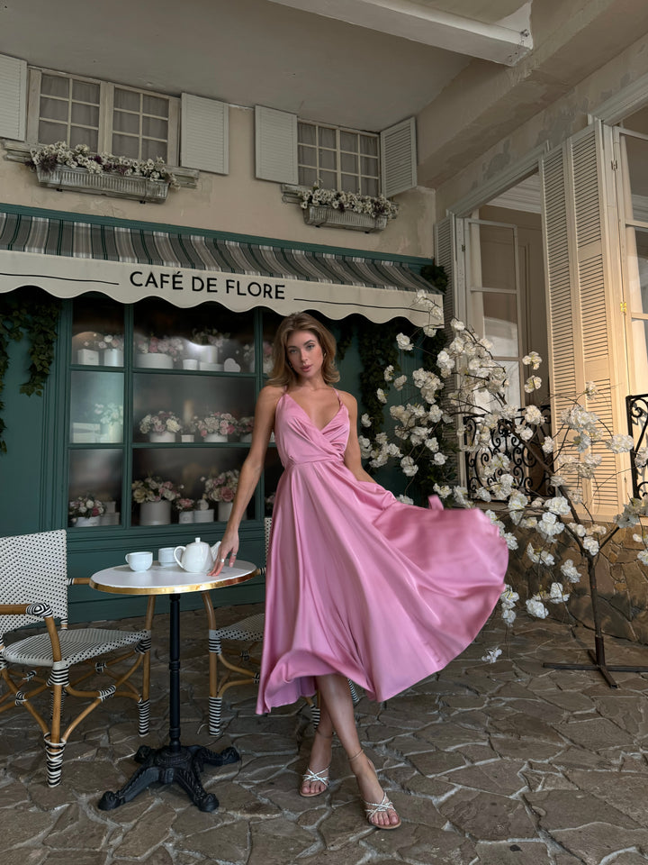 Dusty pink silk slip midi dress with deep V-neck and open bow back — front view