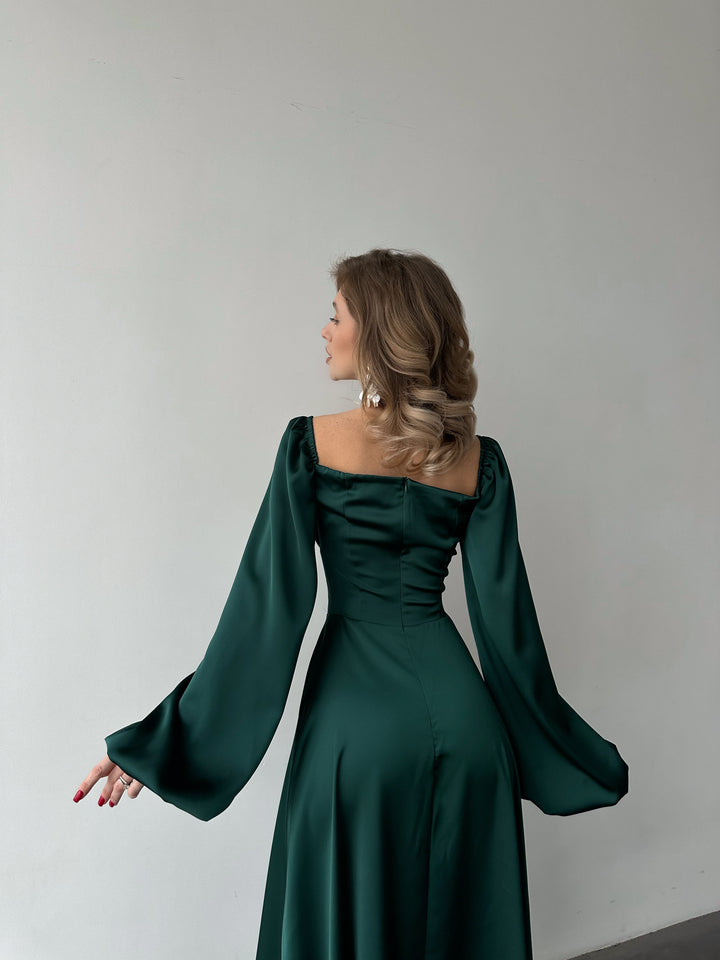 Long-sleeve emerald green silk-blend formal dress highlighting a fitted bodice and sweeping maxi skirt. Ideal for an upscale bridesmaid dress.