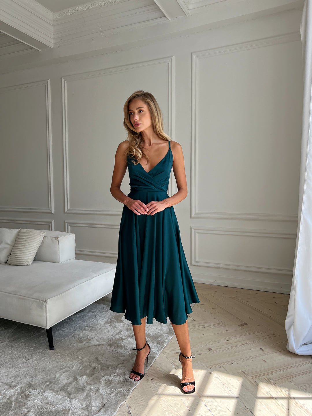 Emerald silk satin midi dress — movement and drape close up