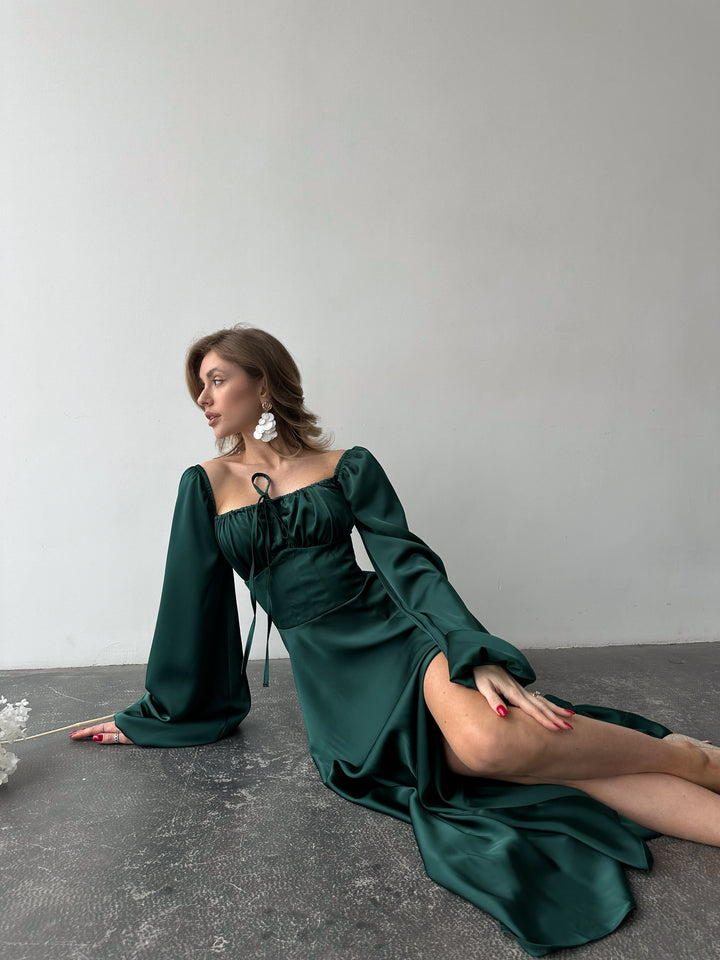 Elegant emerald green long-sleeve silk gown with a sweeping floor-length hem and sweetheart cut. An upscale option for a romantic date night.