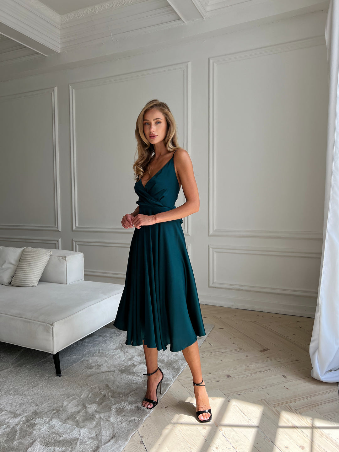 Emerald green silk dress with flowing silhouette and open back