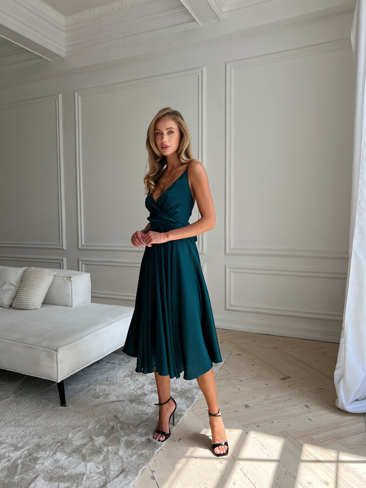 Emerald green silk dress with flowing silhouette and open back