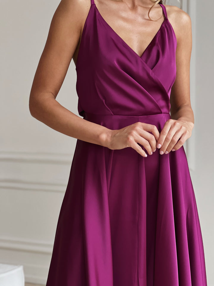Side profile of fuchsia silk slip dress with adjustable shoulder straps