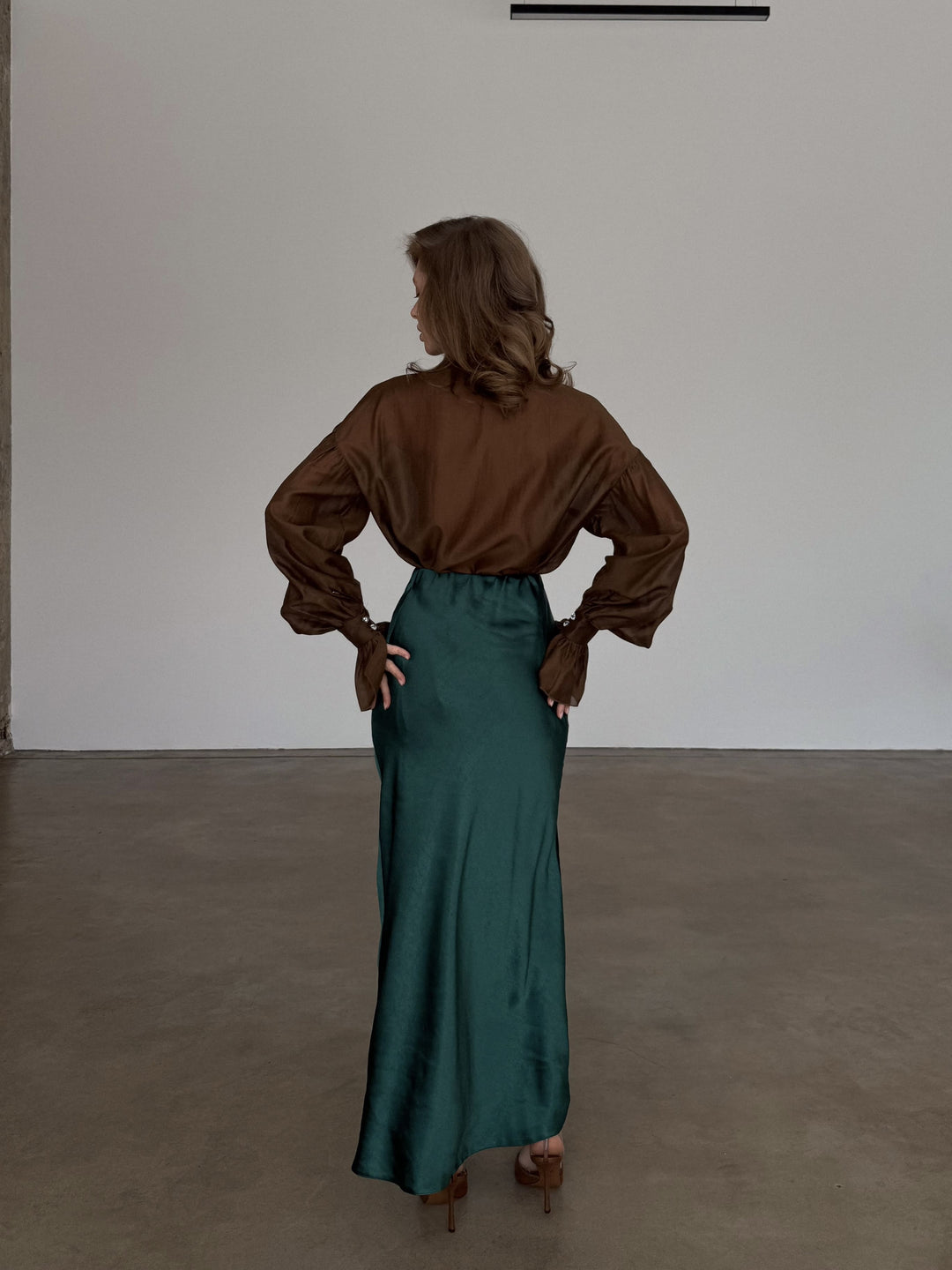 Detailed shot from behind focusing on the smooth transition from the high waist down through the bias-cut fabric.