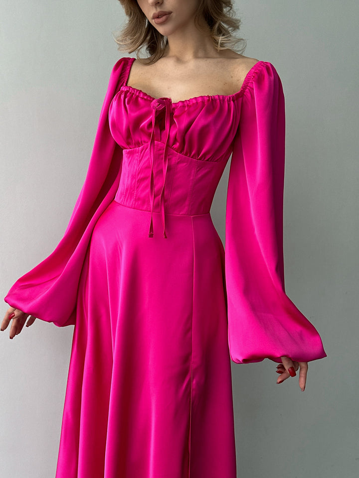 Bubblegum pink long-sleeve evening dress made of smooth satin. Features a structured sweetheart bust and side slit, ideal for a modern bridesmaid dress.
