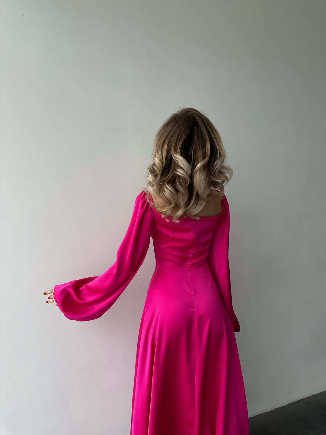 Sophisticated bubblegum pink satin dress offering long cuffed sleeves and a high slit maxi skirt. Perfect for a bold summer wedding guest appearance.
