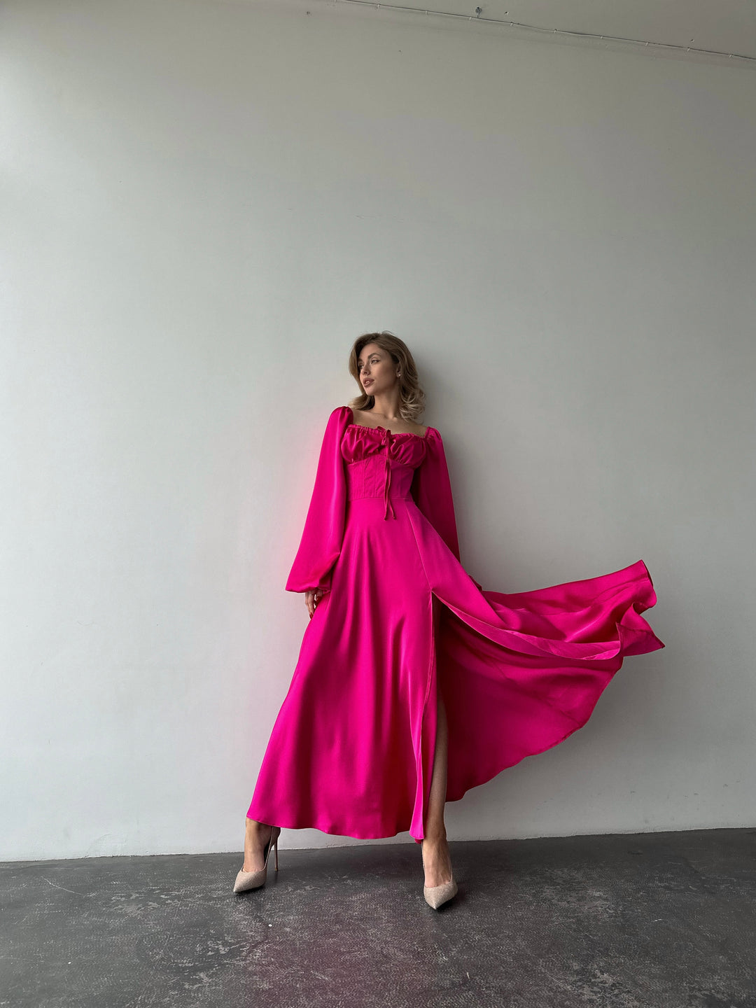 Elegant bubblegum pink satin gown with a sweetheart neckline and dramatic thigh slit. A refined and modern choice for a formal event or spring gala.