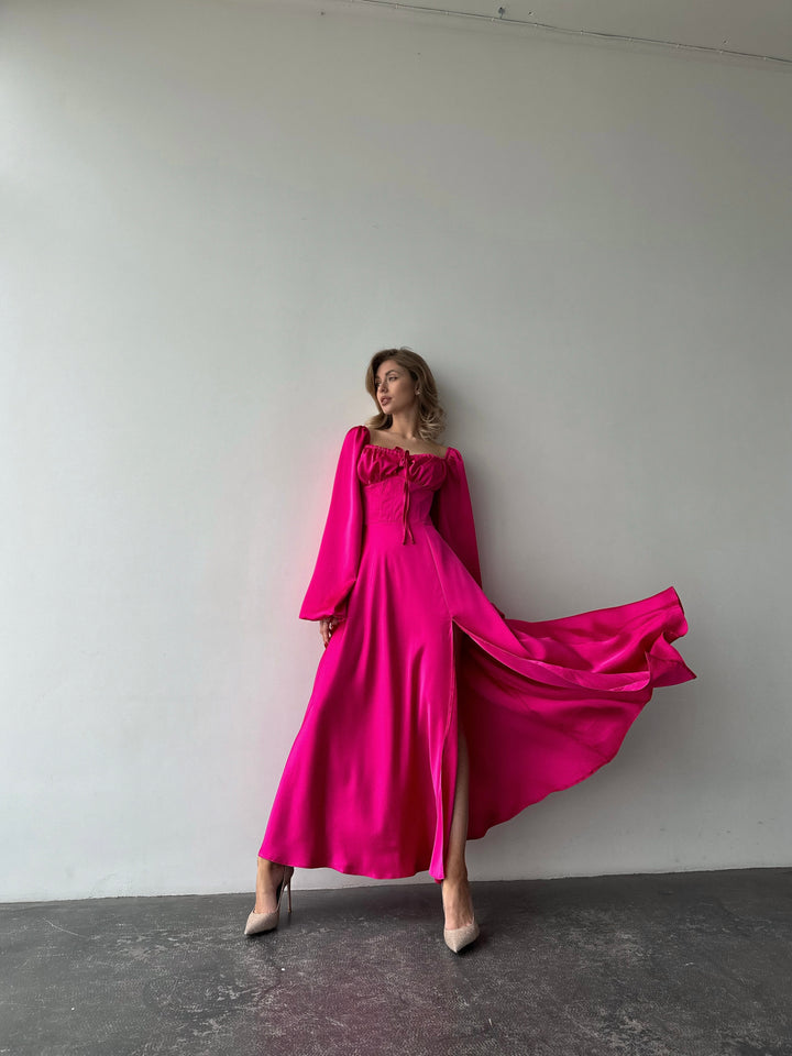 Elegant bubblegum pink satin gown with a sweetheart neckline and dramatic thigh slit. A refined and modern choice for a formal event or spring gala.