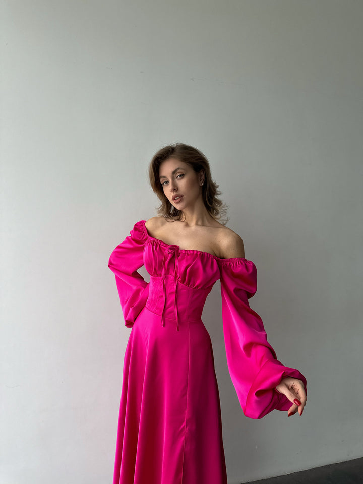 Vibrant hot pink long-sleeve silk gown with a sweeping floor-length hem and sweetheart cut. An upscale option for a romantic date night or evening out.