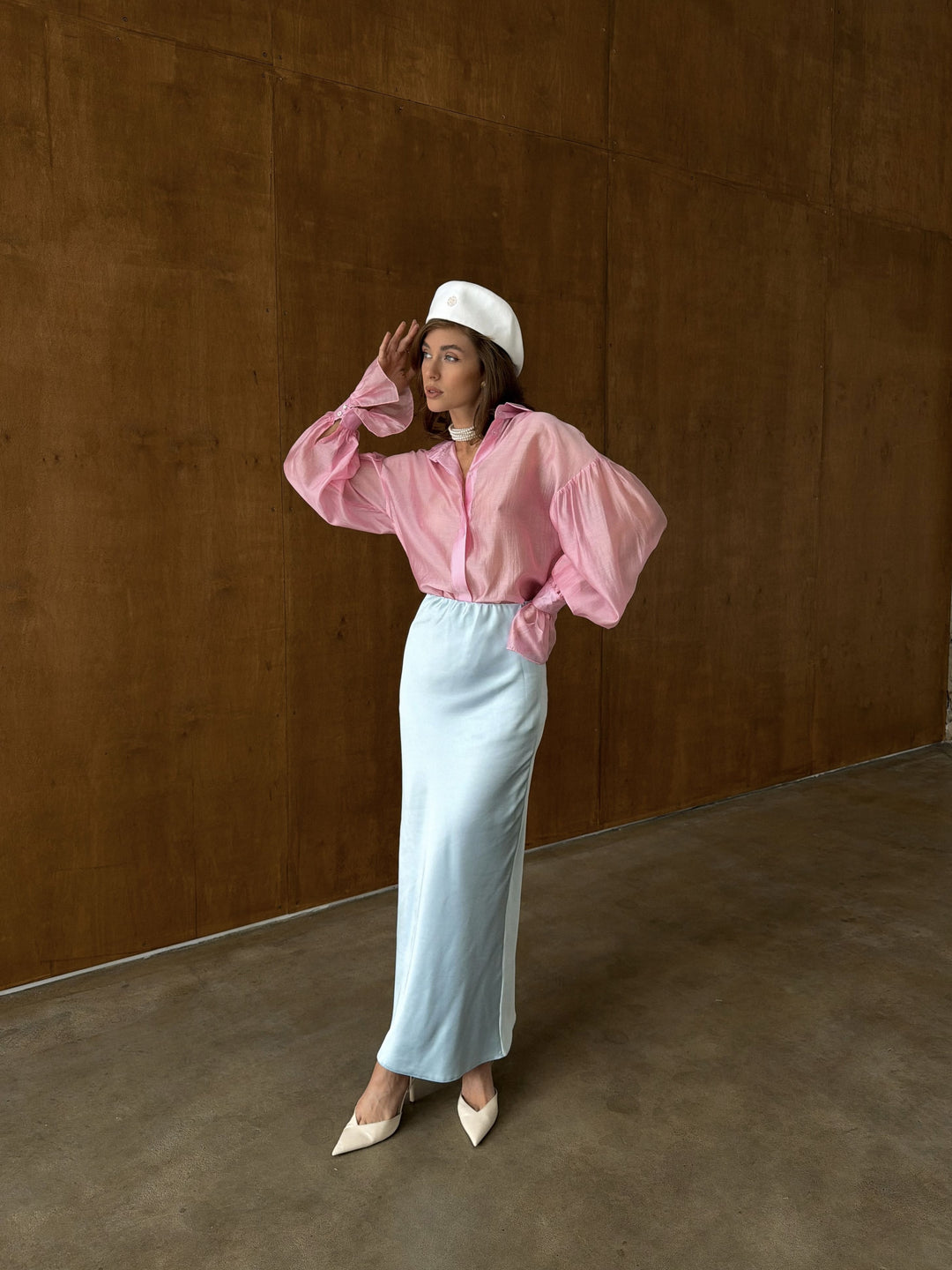 Front view of the ice blue satin midi skirt with the elastic waistband showing the smooth gathered construction and the transition into the flowing A-line body