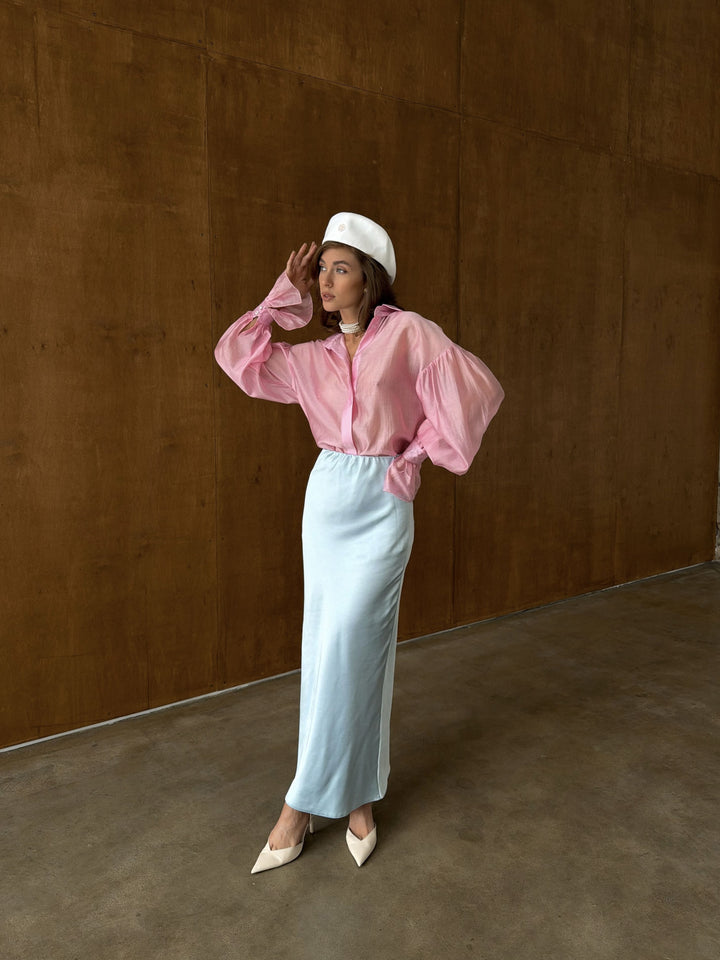 Front view of the ice blue satin midi skirt with the elastic waistband showing the smooth gathered construction and the transition into the flowing A-line body