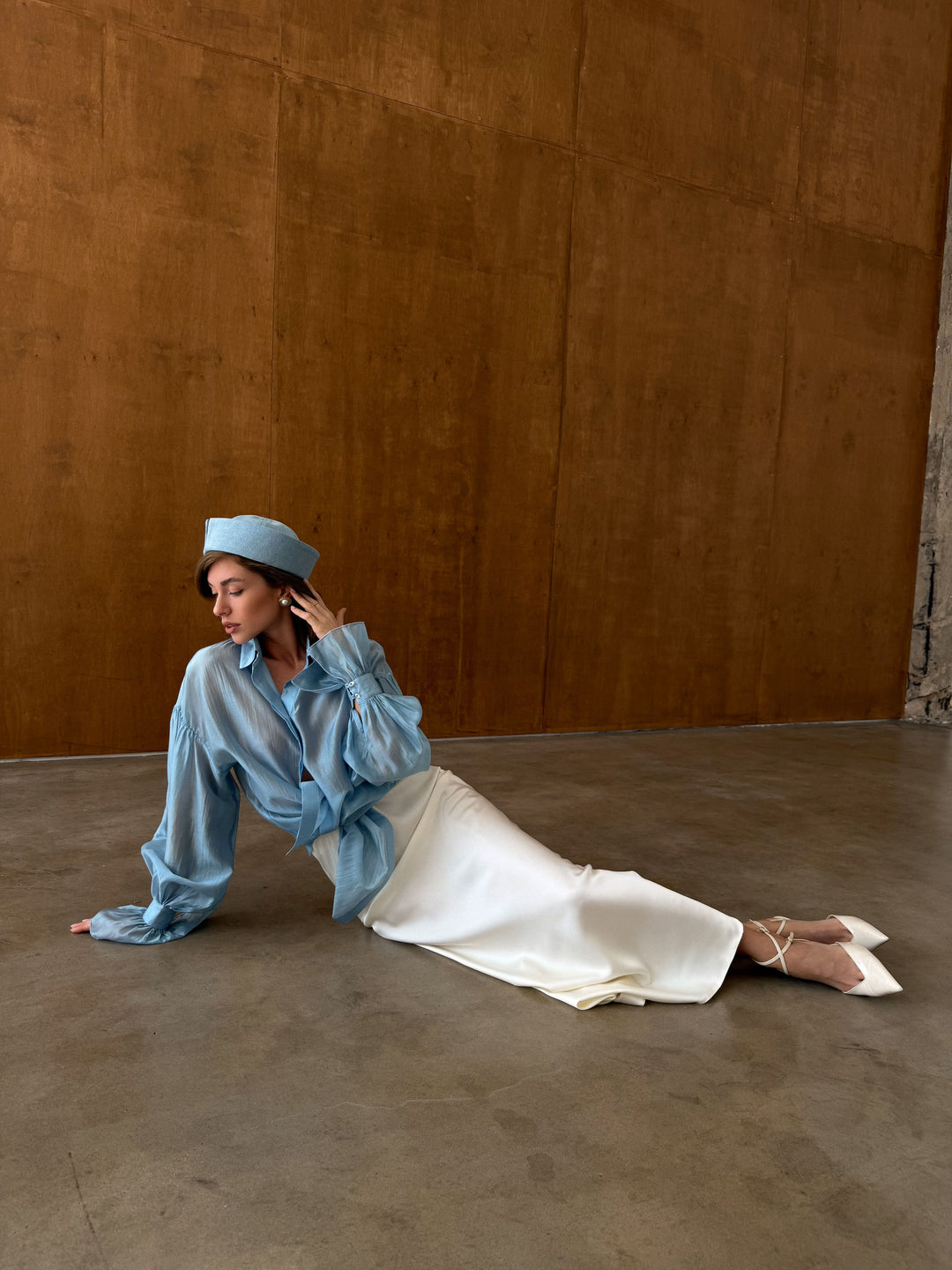 Ivory bias cut satin skirt with fluid shape and soft shine.