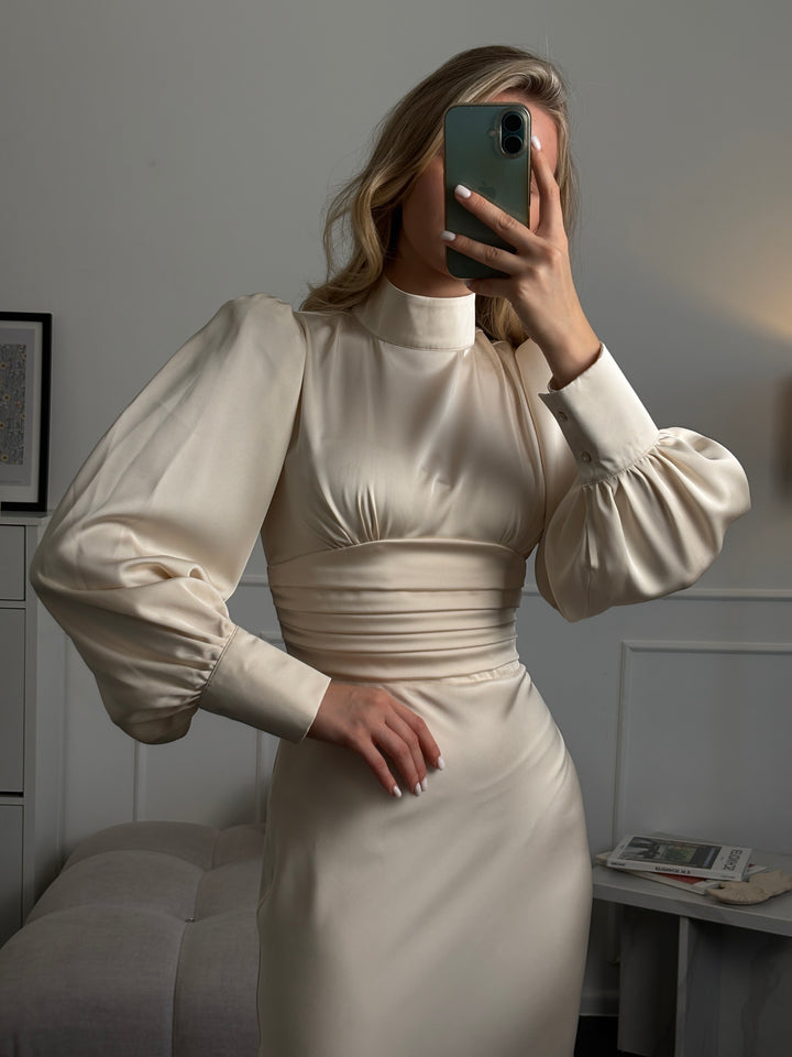Modest ivory satin midi dress with long sleeves and bow neckline, perfect wedding guest or civil ceremony outfit for modern brides