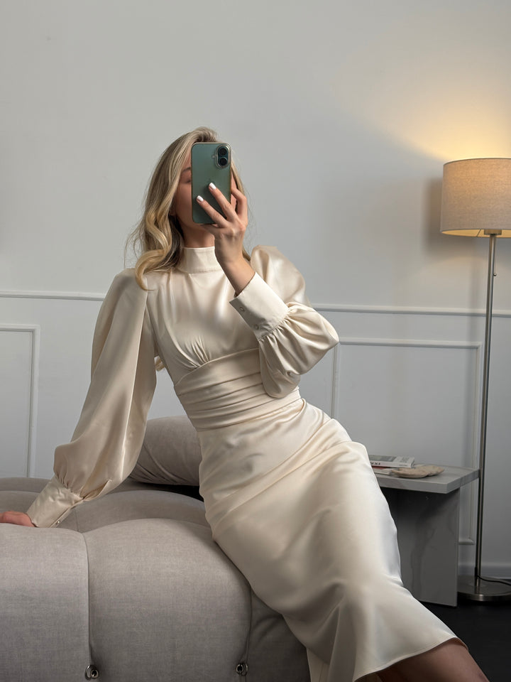 Ivory satin midi dress with fitted silhouette and bow detail, ideal for wedding guest, bridal shower, or romantic date night