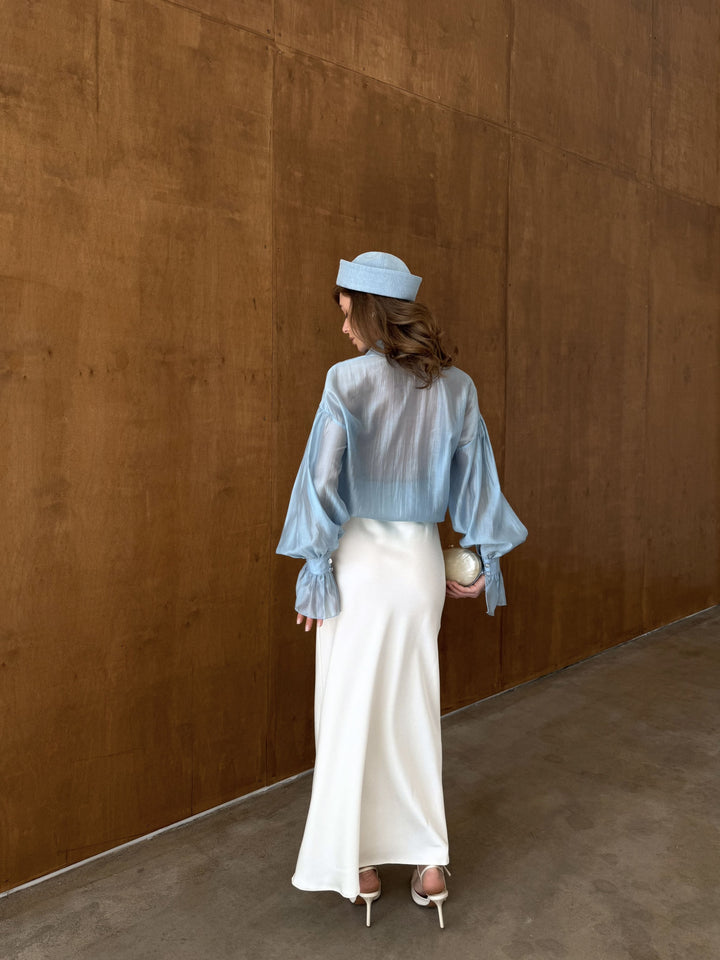 Back view of the ivory satin skirt with subtle sheen and smooth texture.
