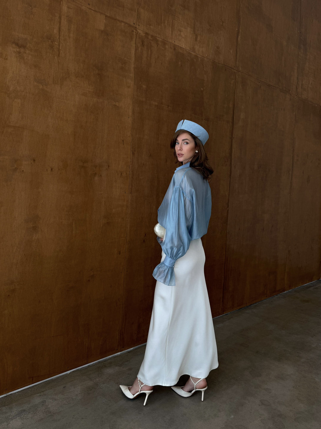 Ivory satin midi skirt with clean lines and fluid movement.