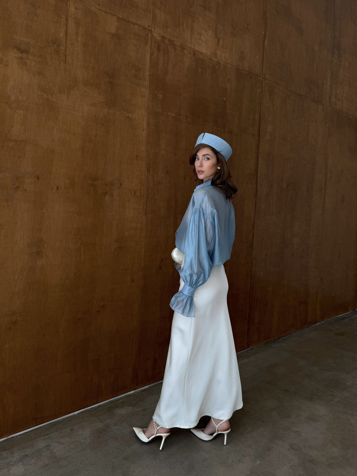 Ivory satin midi skirt with clean lines and fluid movement.