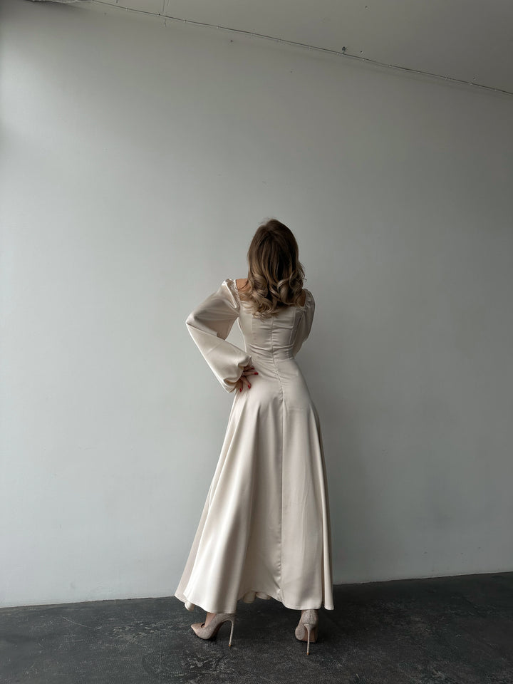 Ivory silk satin maxi dress full back view — bishop sleeves, flowing floor-length satin skirt with rich drape. Perfect for brides, elopements, rehearsal dinners, and elegant evening events.