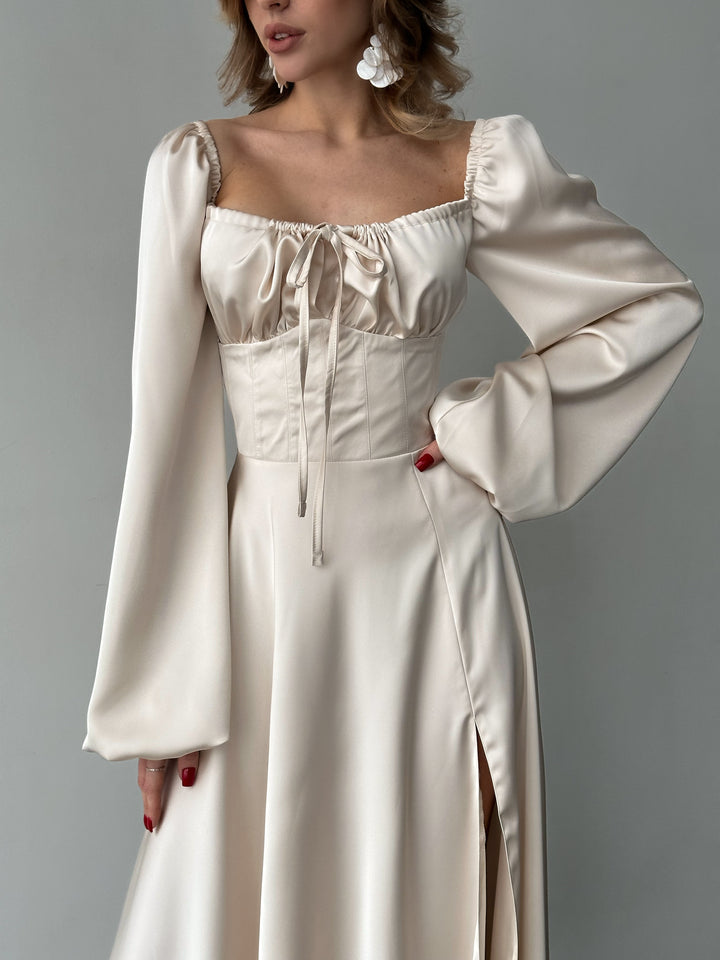 Ivory silk satin maxi dress with bishop sleeves and lace-up corset front detail — sweetheart neckline and high slit. Elegant, floor-length. Perfect for elopements, civil weddings, bridal receptions, and formal evening events.