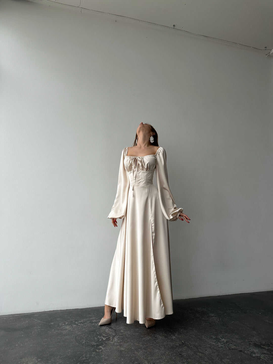 Ivory silk satin maxi dress full-length standing view — bishop sleeves, sweetheart neckline, floor-sweeping skirt. Elegant modest bridal silhouette. Perfect for civil ceremonies, bridal receptions, and formal occasions.