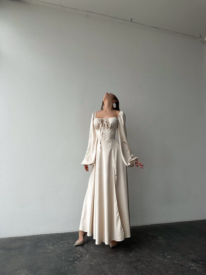 Ivory silk satin maxi dress full-length standing view — bishop sleeves, sweetheart neckline, floor-sweeping skirt. Elegant modest bridal silhouette. Perfect for civil ceremonies, bridal receptions, and formal occasions.