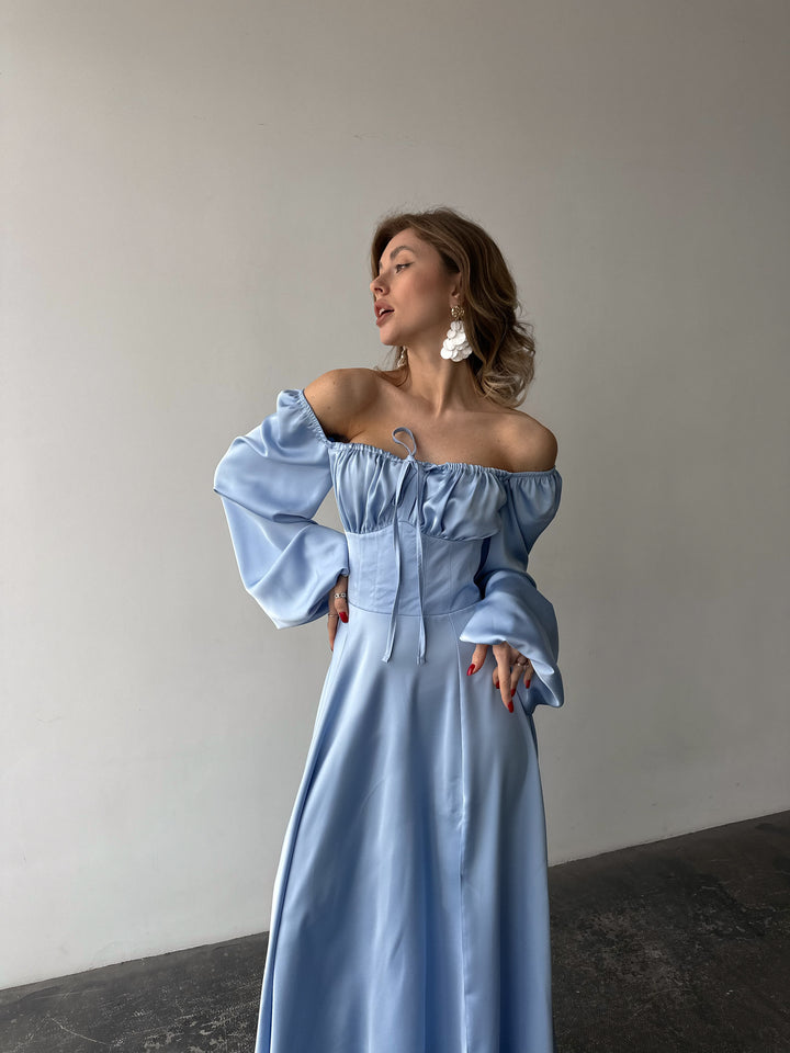Sophisticated pastel blue satin dress offering long cuffed sleeves and a high slit maxi skirt. Perfect for a chic summer wedding guest appearance.