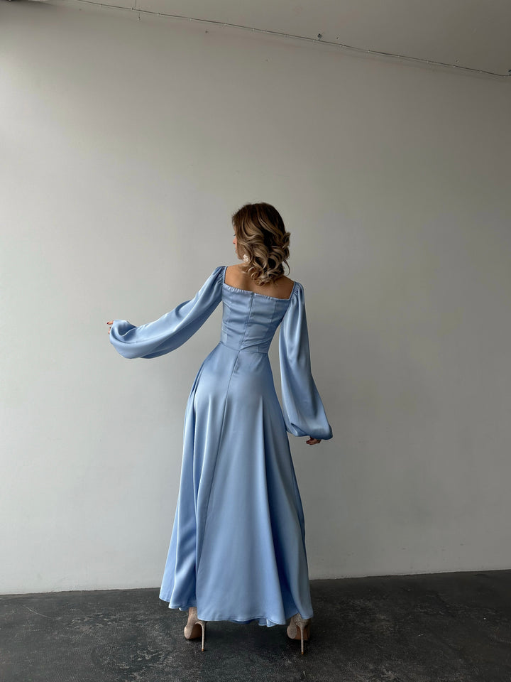Floor-length pastel blue satin dress with a flattering sweetheart neckline and versatile draped sleeves. A refined silhouette perfect for a stylish date night.
