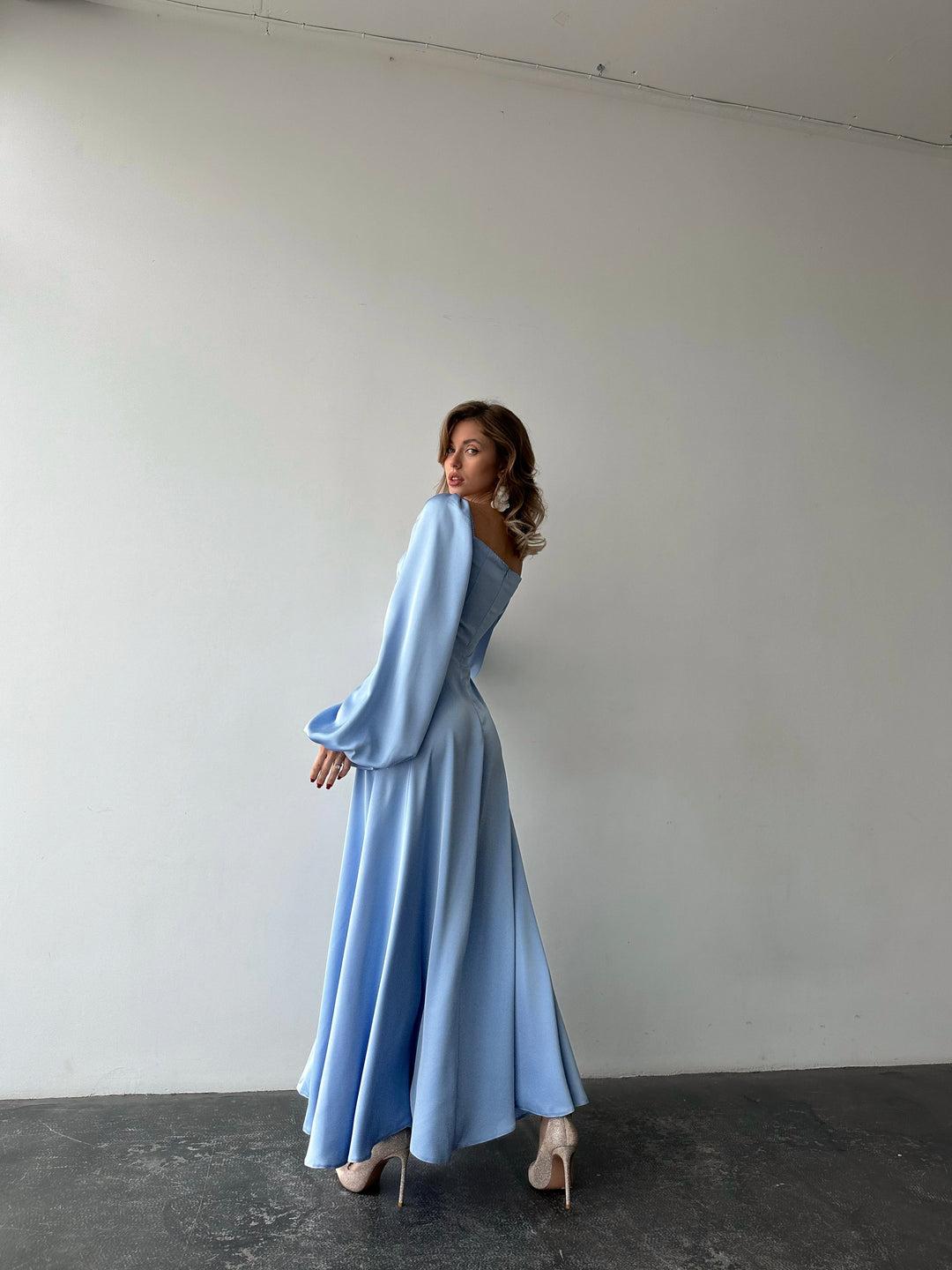 Long-sleeve ice blue silk-blend formal dress highlighting a fitted bodice and sweeping maxi skirt. Ideal for an upscale light blue bridesmaid dress look.