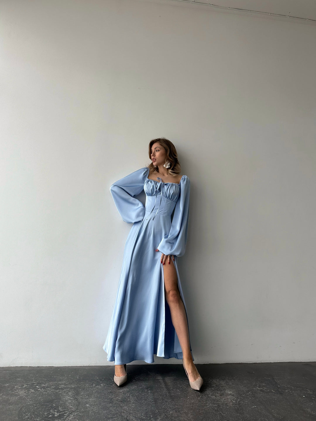 Beautifully draped ice blue silk dress featuring a feminine sweetheart neckline and long balloon sleeves. A luxurious outfit choice for a formal spring gala.
