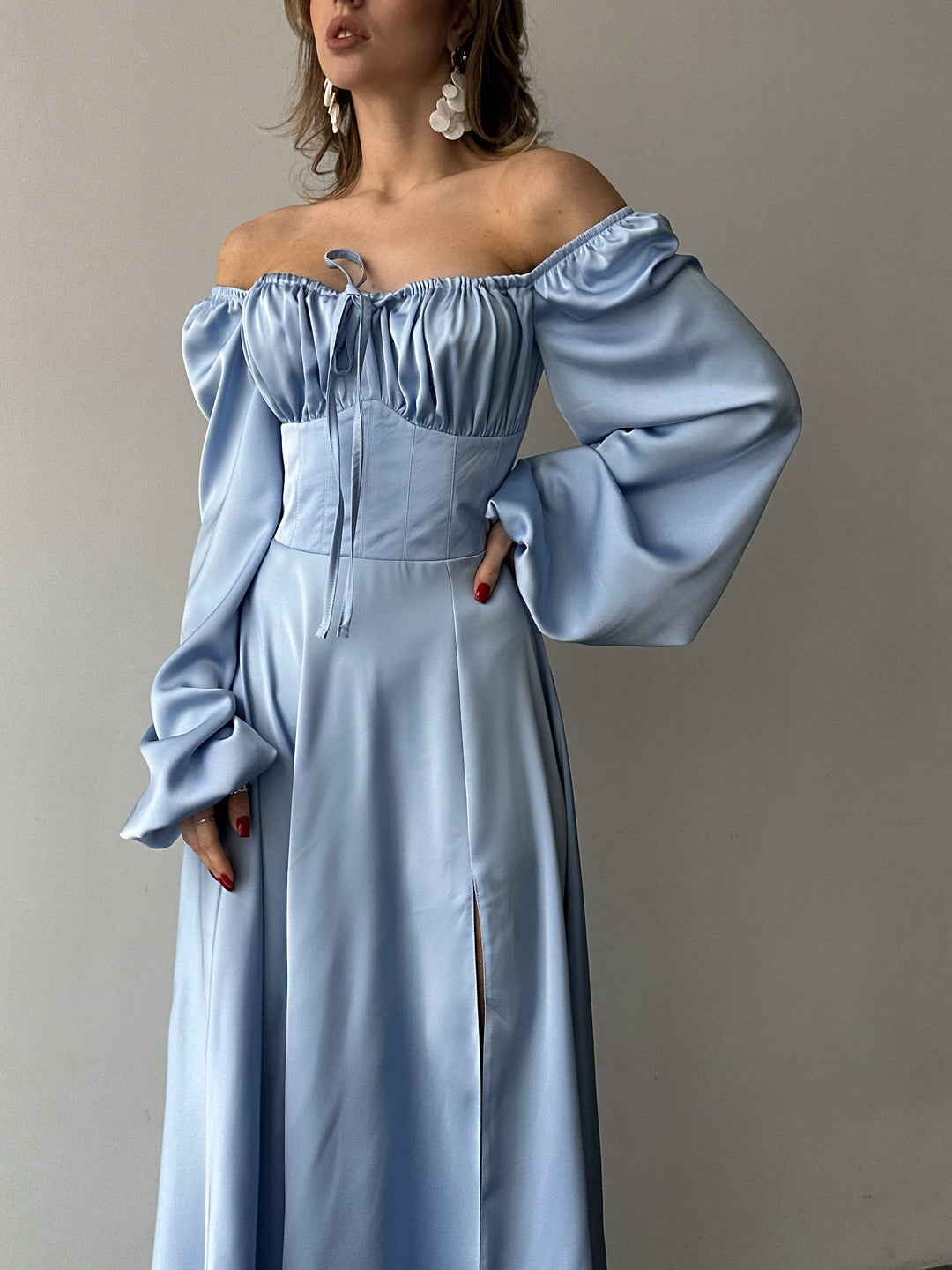 Chic ice blue silk formal maxi dress with on-or-off shoulder puff sleeves. A vibrant aesthetic perfect for a fashionable NYC style cocktail dress look.