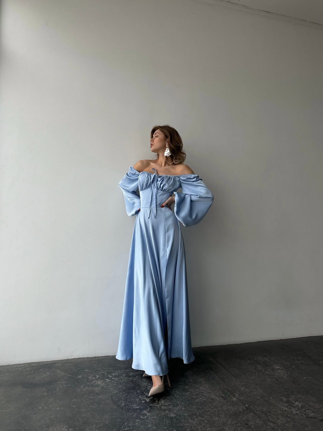 Elegant ice blue long-sleeve silk gown with a sweeping floor-length hem and sweetheart cut. An upscale option for a luxurious spring bridesmaid dress.