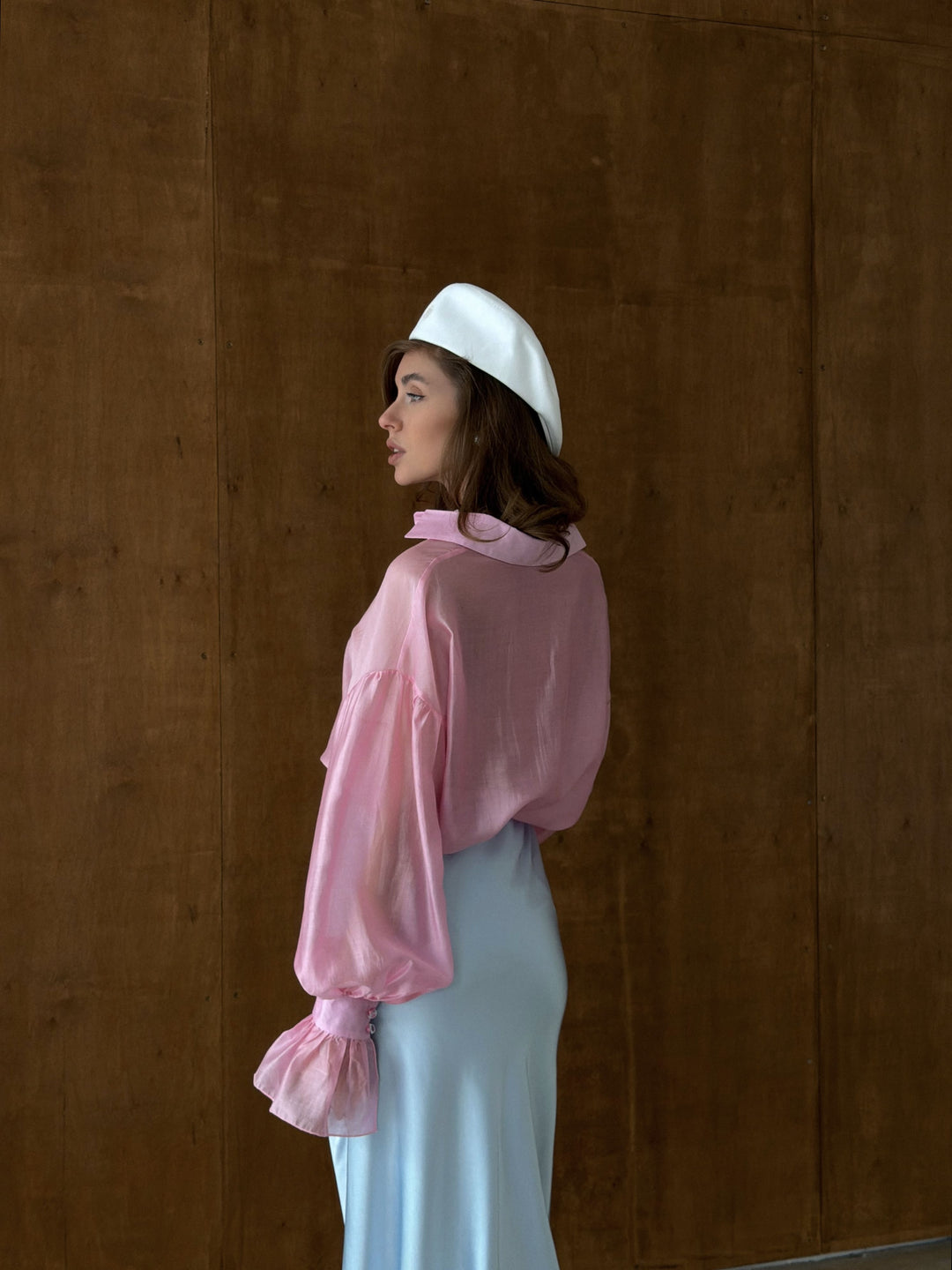 Back view of pink sheer blouse with dropped shoulders and clean yoke construction