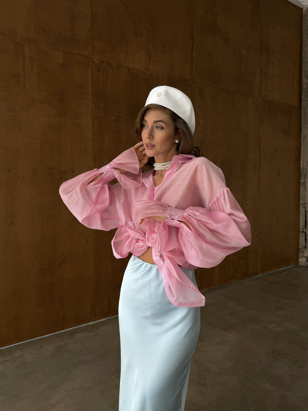 Close-up of the full button placket on the bubblegum pink sheer blouse