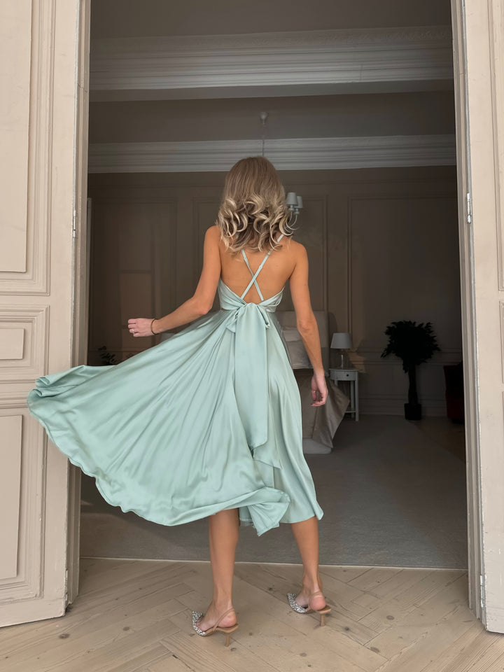 Pistachio green silk slip dress — fabric drape and texture close up