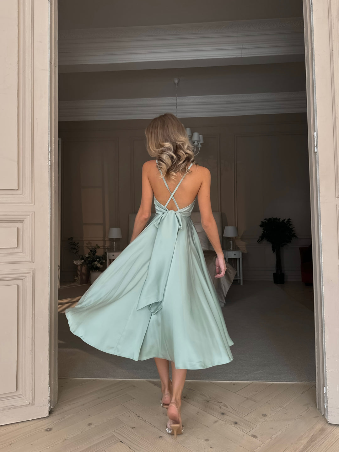 Soft pistachio silk midi dress with elegant V-neckline and open back