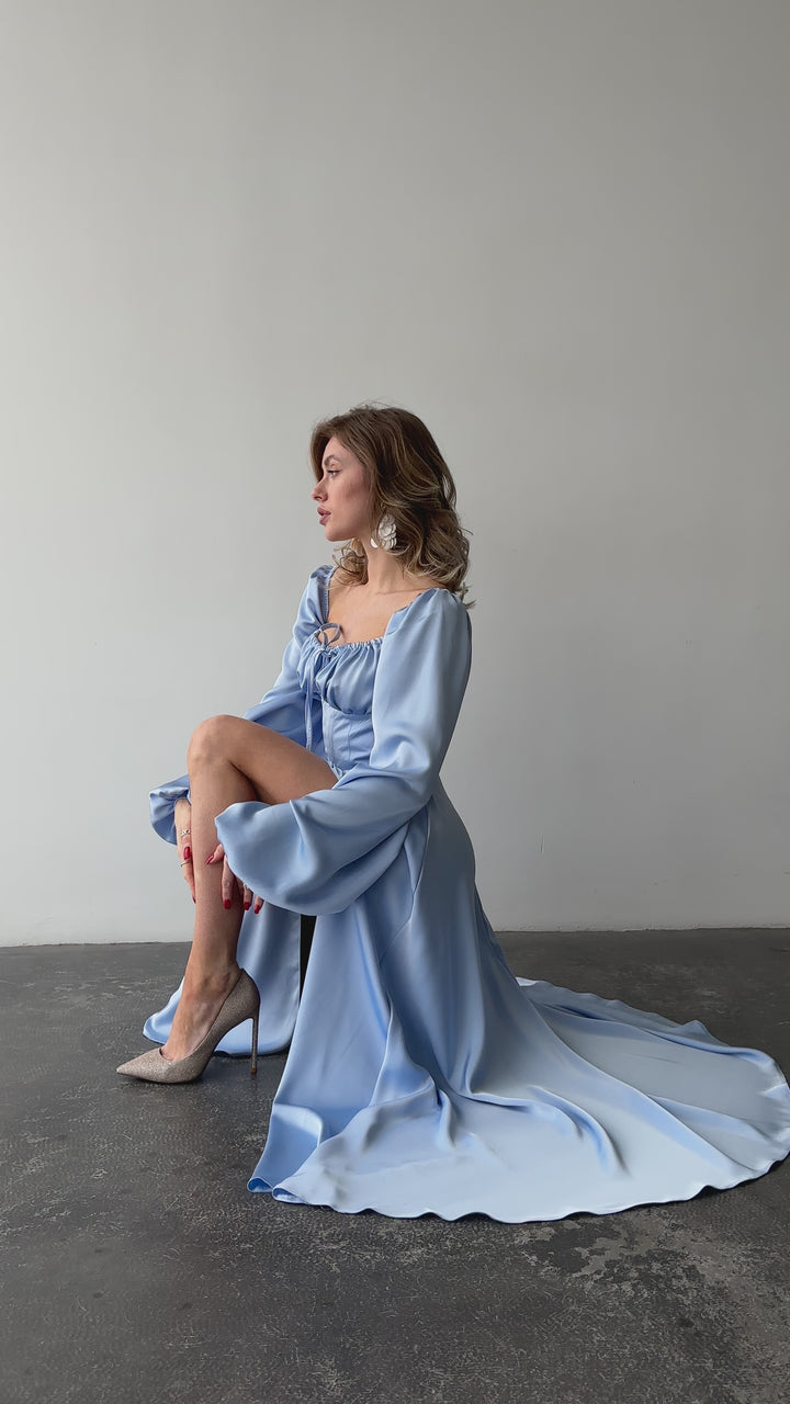 Light blue silk satin maxi dress with bishop sleeves and high leg slit modelled in motion — EvolveUA