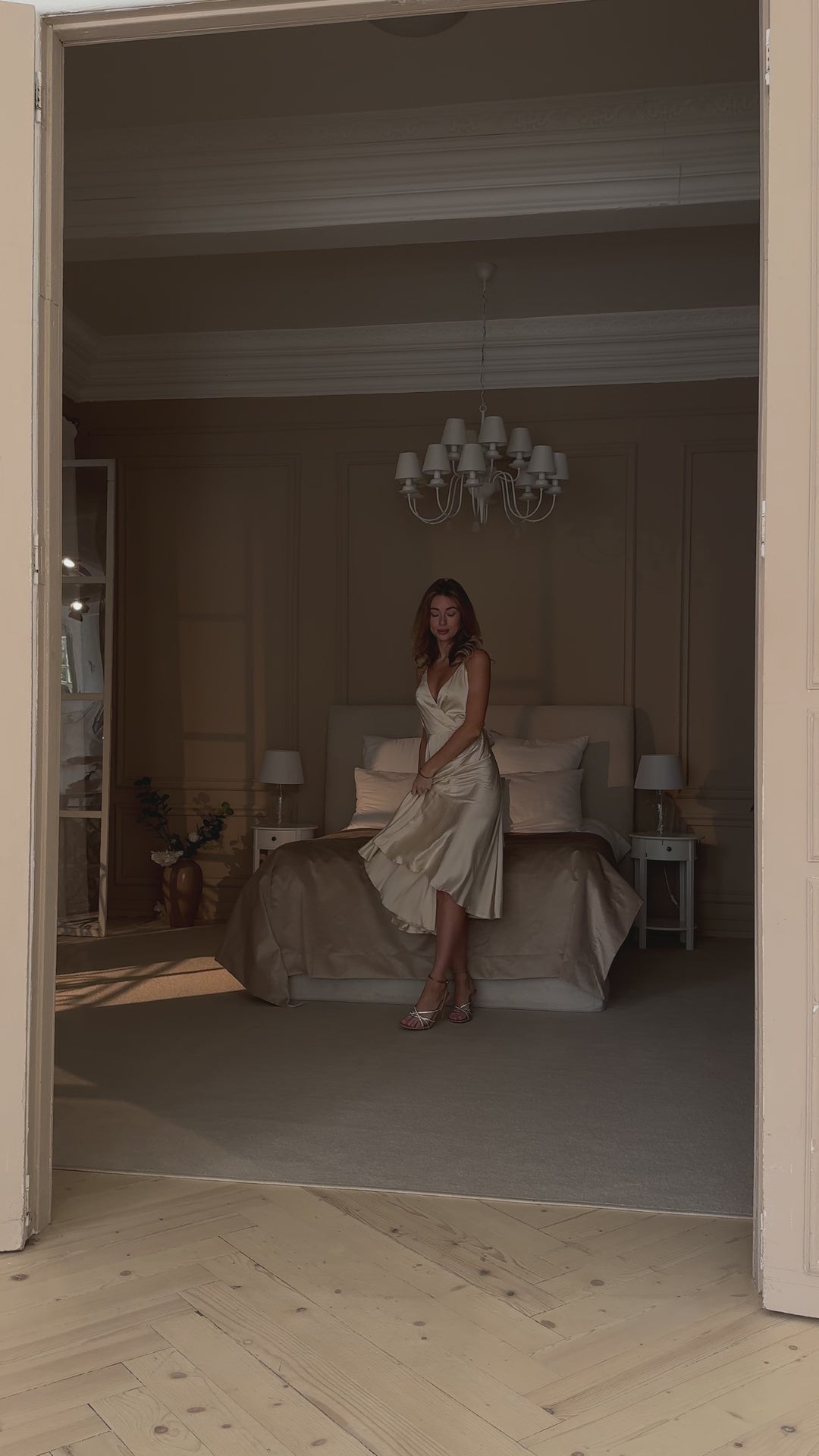 Vanilla silk slip midi dress with deep V-neck and open back modelled in motion — EvolveUA
